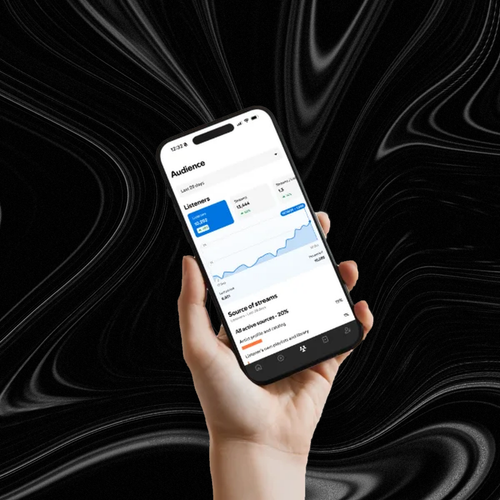 Spotify for Artists audience growth on a phone, held against a black marbled background